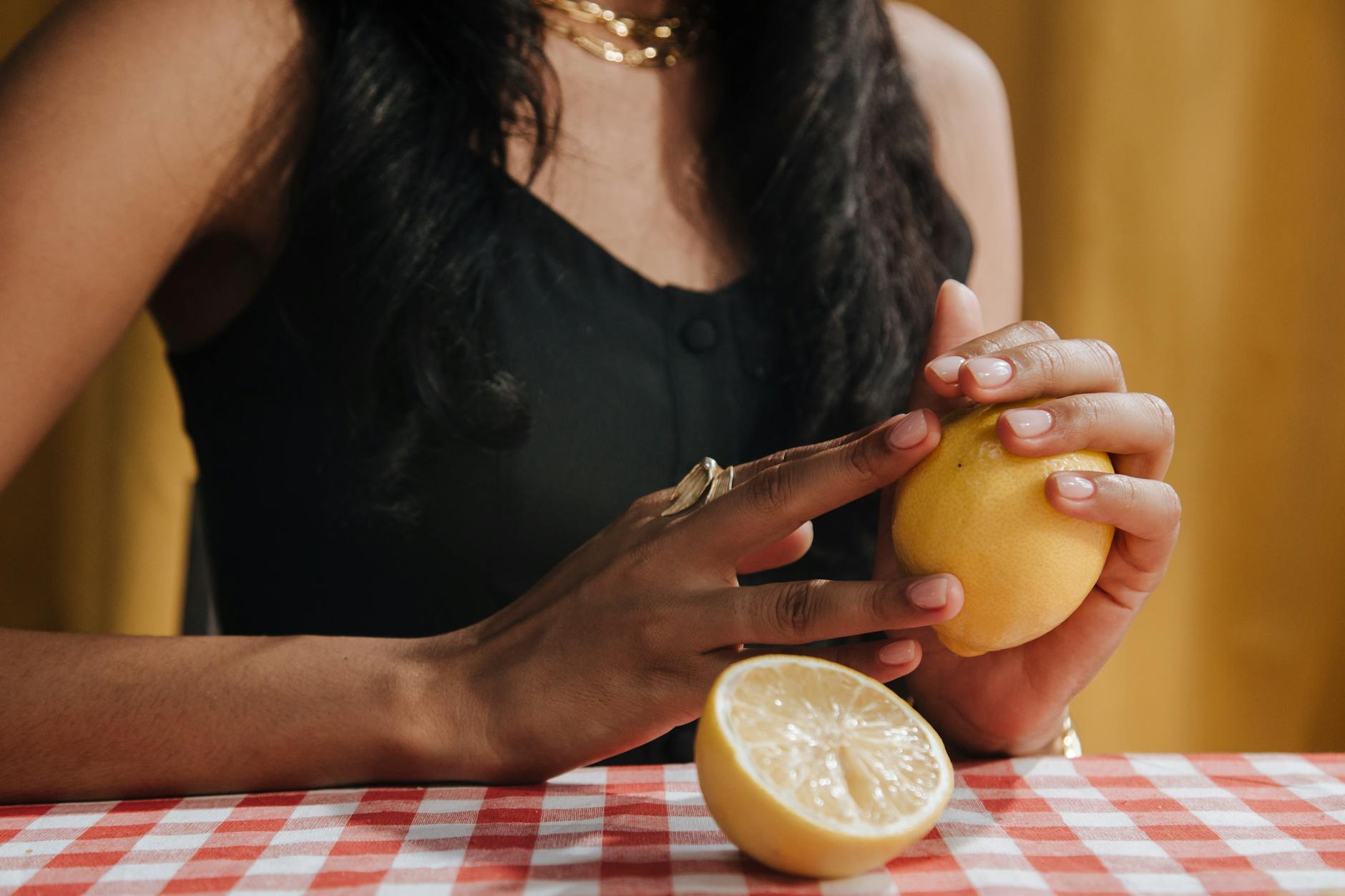 Close-up of hands holding a vibrator against a minimalist purple backdrop