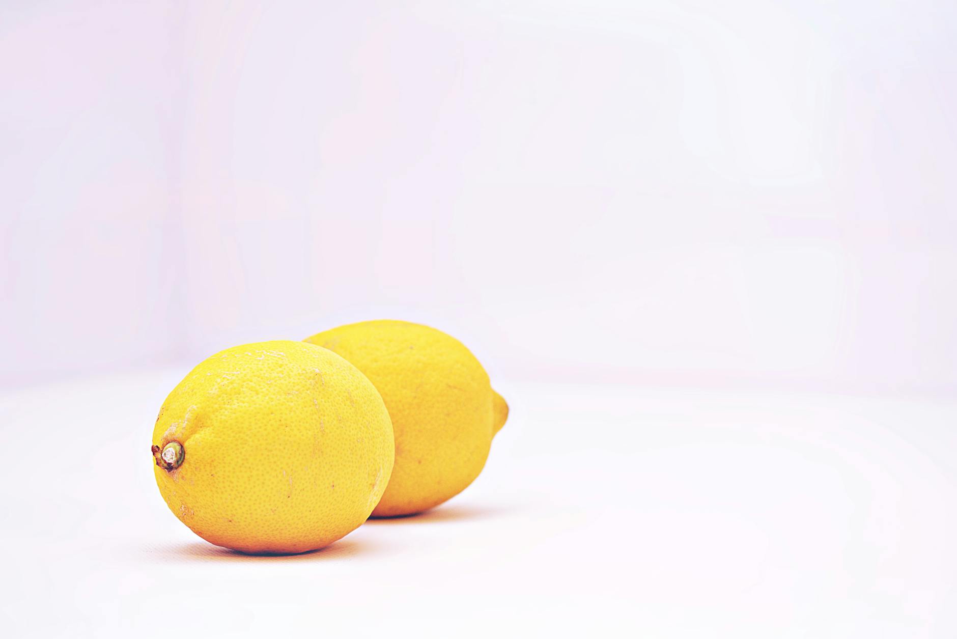 Fresh lemons on a white background, symbolizing refreshed sensation and clarity