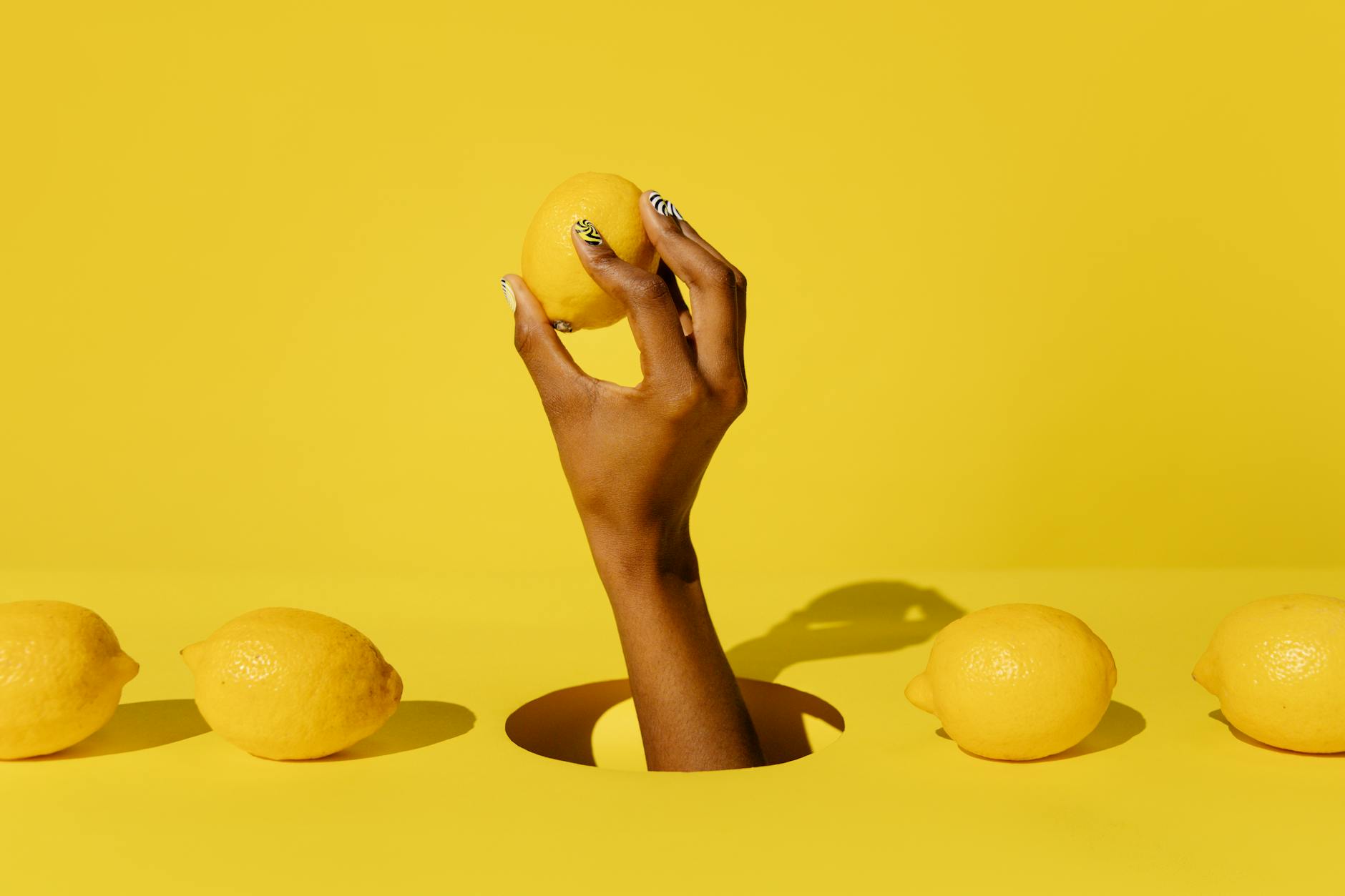A yellow clitoral vibrator arranged on a bright yellow background, representing sensory-friendly pleasure devices