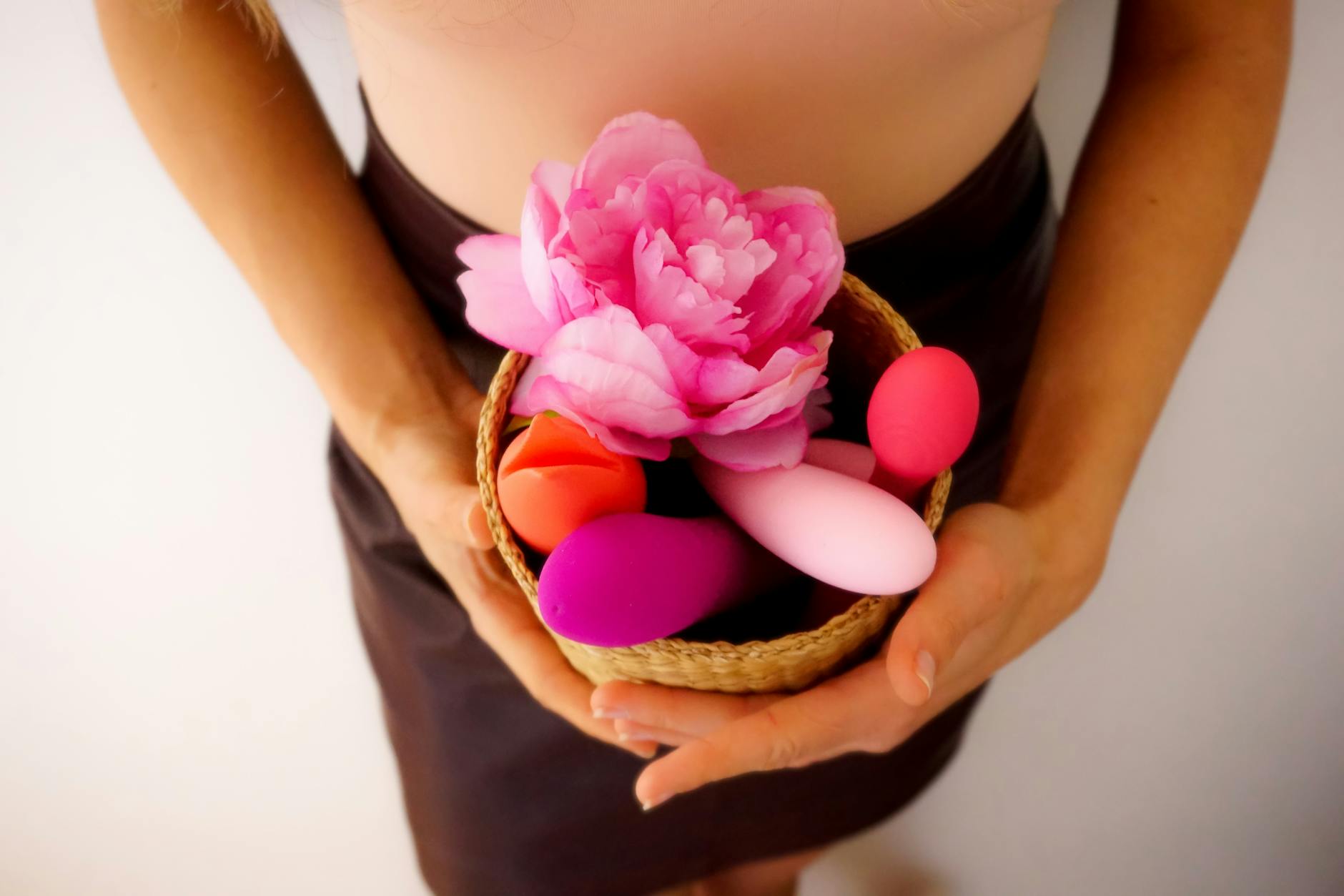 Vibrant display of silicone sex toys on dark blue fabric, showcasing various colors and shapes